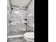 Shower with marble-look tile and built-in shelving at 7301 Pierce Harwell Rd, Plant City, FL 33565