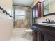 Updated bathroom with dark wood vanity, granite countertop, and tile shower at 7301 Pierce Harwell Rd, Plant City, FL 33565