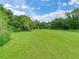 Expansive pastureland bordered by lush vegetation at 7301 Pierce Harwell Rd, Plant City, FL 33565