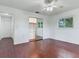 Bedroom with hardwood floors, mirrored closet doors and ceiling fan at 7301 Pierce Harwell Rd, Plant City, FL 33565