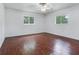 Bright bedroom with hardwood floors and ceiling fan at 7301 Pierce Harwell Rd, Plant City, FL 33565