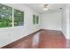 Bright living room features hardwood floors and large windows at 7301 Pierce Harwell Rd, Plant City, FL 33565