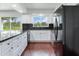 Modern kitchen with stainless steel appliances and view to backyard at 7301 Pierce Harwell Rd, Plant City, FL 33565
