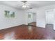 Bedroom with hardwood floors, mirrored closet doors and ceiling fan at 7301 Pierce Harwell Rd, Plant City, FL 33565
