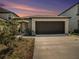 Charming house with a brown garage door and landscaping at 16762 Delia St, Wimauma, FL 33598