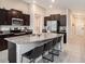 Modern kitchen with large island and granite countertops at 16762 Delia St, Wimauma, FL 33598