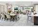 Open concept dining room with seating for six, adjacent to the living room and kitchen at 13714 Heartwood Way, Parrish, FL 34219