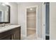 Bathroom with marble vanity and walk-in closet at 17307 Linda Vista Cir, Lutz, FL 33548