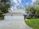 Two-car garage with long driveway, offering ample parking at 17307 Linda Vista Cir, Lutz, FL 33548