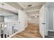 Upstairs hallway with wood-look floors and access to bedrooms at 17307 Linda Vista Cir, Lutz, FL 33548