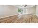 Living room with wood-look floors and access to bathroom at 17307 Linda Vista Cir, Lutz, FL 33548