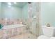 Tiled bathroom featuring a glass-enclosed shower, luxurious bathtub, and modern fixtures at 4950 Bayshore Blvd # 13C, Tampa, FL 33611