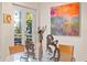 Elegant dining area with glass table, chairs, and large colorful art at 4950 Bayshore Blvd # 13C, Tampa, FL 33611