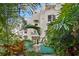 Building exterior partially obscured by tropical foliage at 4950 Bayshore Blvd # 13C, Tampa, FL 33611