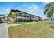 Condo building showcasing a well-maintained exterior and lush green lawns at 4600 Marine Parkway # 104, New Port Richey, FL 34652