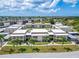 Aerial view of a condo community showing building exteriors, landscaping, and parking at 4600 Marine Parkway # 104, New Port Richey, FL 34652