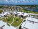 Aerial view of community with lush landscaping and waterfront at 4600 Marine Parkway # 104, New Port Richey, FL 34652