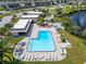 L-shaped pool with plenty of lounge chairs and tables for entertaining at 4600 Marine Parkway # 104, New Port Richey, FL 34652
