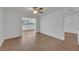 Bright living room with wood-look floors and access to a sunroom at 4600 Marine Parkway # 104, New Port Richey, FL 34652