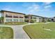 Condo building with a side view showcasing its architecture and landscaping at 4600 Marine Parkway # 104, New Port Richey, FL 34652