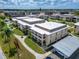 Aerial view of condo building, showcasing its design and surrounding landscape at 4600 Marine Parkway # 104, New Port Richey, FL 34652