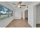 Bedroom with laminate flooring, ceiling fan and access to hallway at 4600 Marine Parkway # 104, New Port Richey, FL 34652
