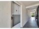 Condo building entrance with a security door and neutral colored walls at 4600 Marine Parkway # 104, New Port Richey, FL 34652