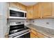 Kitchen features granite countertops and modern stovetop at 4600 Marine Parkway # 104, New Port Richey, FL 34652
