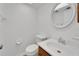 Clean bathroom with single sink vanity, toilet, and large mirror at 4600 Marine Parkway # 104, New Port Richey, FL 34652