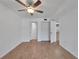 Spacious bedroom featuring a ceiling fan, laminate floors, and built-in closet at 4600 Marine Parkway # 104, New Port Richey, FL 34652