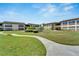 Community with green lawns, walkways and building exteriors at 4600 Marine Parkway # 104, New Port Richey, FL 34652