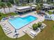 Community pool with surrounding patio furniture and picnic tables at 4600 Marine Parkway # 104, New Port Richey, FL 34652