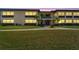 Condo building at dusk, showing the well-lit entrance and landscaping at 4600 Marine Parkway # 104, New Port Richey, FL 34652