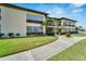 Condo building with a welcoming entrance and neatly landscaped grounds at 4600 Marine Parkway # 104, New Port Richey, FL 34652