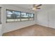 Bright bedroom with laminate wood flooring and sliding glass doors to a patio at 4600 Marine Parkway # 104, New Port Richey, FL 34652
