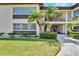 Condo building exterior showcasing landscaping and walkway at 4600 Marine Parkway # 104, New Port Richey, FL 34652