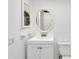 Bathroom boasts a vanity, toilet, and oval mirror at 4600 Marine Parkway # 104, New Port Richey, FL 34652