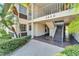 Condo building entrance with stairs and landscaping at 4600 Marine Parkway # 104, New Port Richey, FL 34652