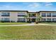 Attractive condo building with manicured landscaping and ample parking at 4600 Marine Parkway # 104, New Port Richey, FL 34652