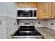 Close-up of the modern stovetop in the kitchen at 4600 Marine Parkway # 104, New Port Richey, FL 34652