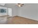Bright bedroom with laminate wood flooring and sliding glass doors to a patio at 4600 Marine Parkway # 104, New Port Richey, FL 34652
