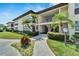 Condo building exterior with palm trees and walkway at 4600 Marine Parkway # 104, New Port Richey, FL 34652