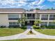 Condo building entrance with walkway and landscaping, offering a welcoming sight at 4600 Marine Parkway # 104, New Port Richey, FL 34652