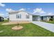 Well-maintained manufactured home with a large grassy front yard at 37601 Neukom Ave, Zephyrhills, FL 33541