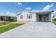 Single-wide manufactured home with carport and landscaped yard at 37601 Neukom Ave, Zephyrhills, FL 33541