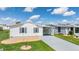 Front view of the home with a carport and landscaping at 37601 Neukom Ave, Zephyrhills, FL 33541