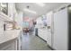 Efficient kitchen with white cabinets and a view of the dining area at 37601 Neukom Ave, Zephyrhills, FL 33541