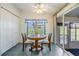 Bright dining area with wood table and chairs, view to backyard at 37601 Neukom Ave, Zephyrhills, FL 33541