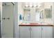 Bathroom with double vanity, shower, and updated fixtures at 37601 Neukom Ave, Zephyrhills, FL 33541