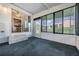 Enclosed Florida room with carpet flooring and access to backyard at 37601 Neukom Ave, Zephyrhills, FL 33541